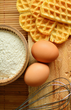 Flour, eggs, waffles, and a whisk
