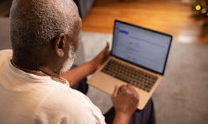 Older gentleman looking at laptop